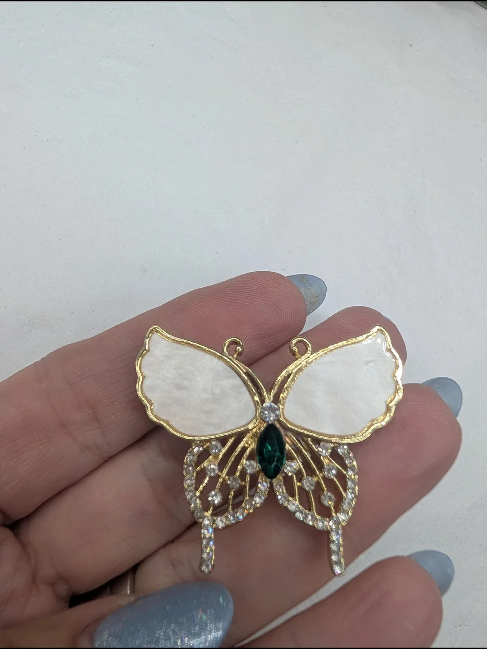 Gold-Tone White Butterfly Pendant with Emerald Center